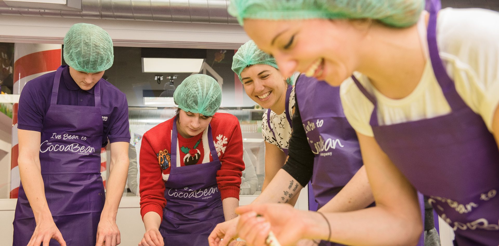 adults making chocolate bars