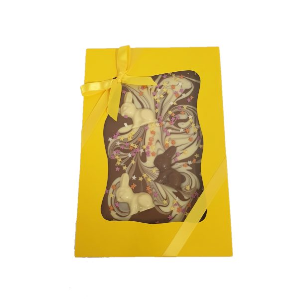 large milk chocolate easter themed slab in yellow box with yellow ribbon