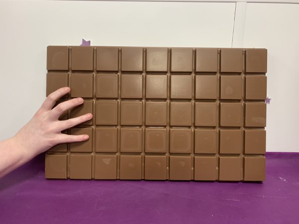giant chocolate bar with hand