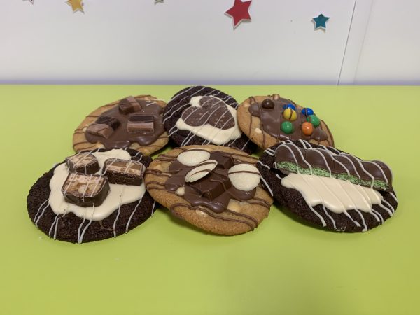 siz decorated cookies on green table