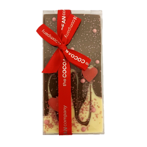 milk and white chocolate bar in valentines decoration with red ribbon