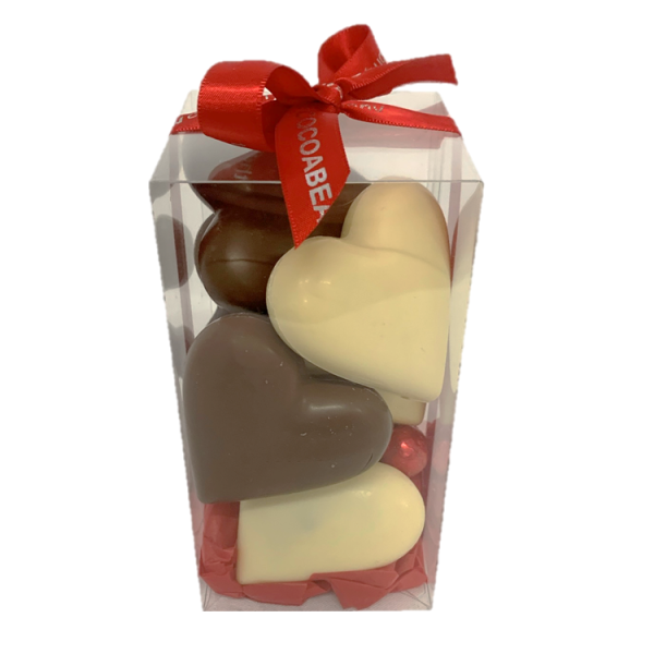 white and milk chocolate hearts in a gift box with red ribbon
