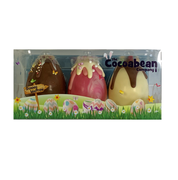 three chocolate easter eggs with chocolate drips and sweets